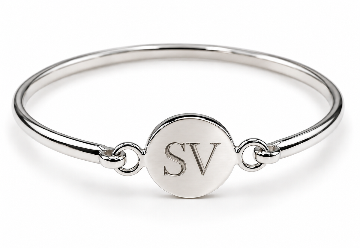 Sterling silver round disc bangle showing an SV initials engraving example.