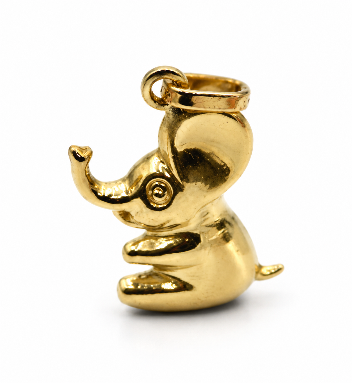 9ct yellow gold sitting elephant pendant charm with uplifted trunk, left-facing view