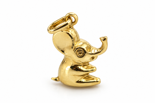 Polished 9ct yellow gold sitting elephant charm with uplifted trunk, right-facing view
