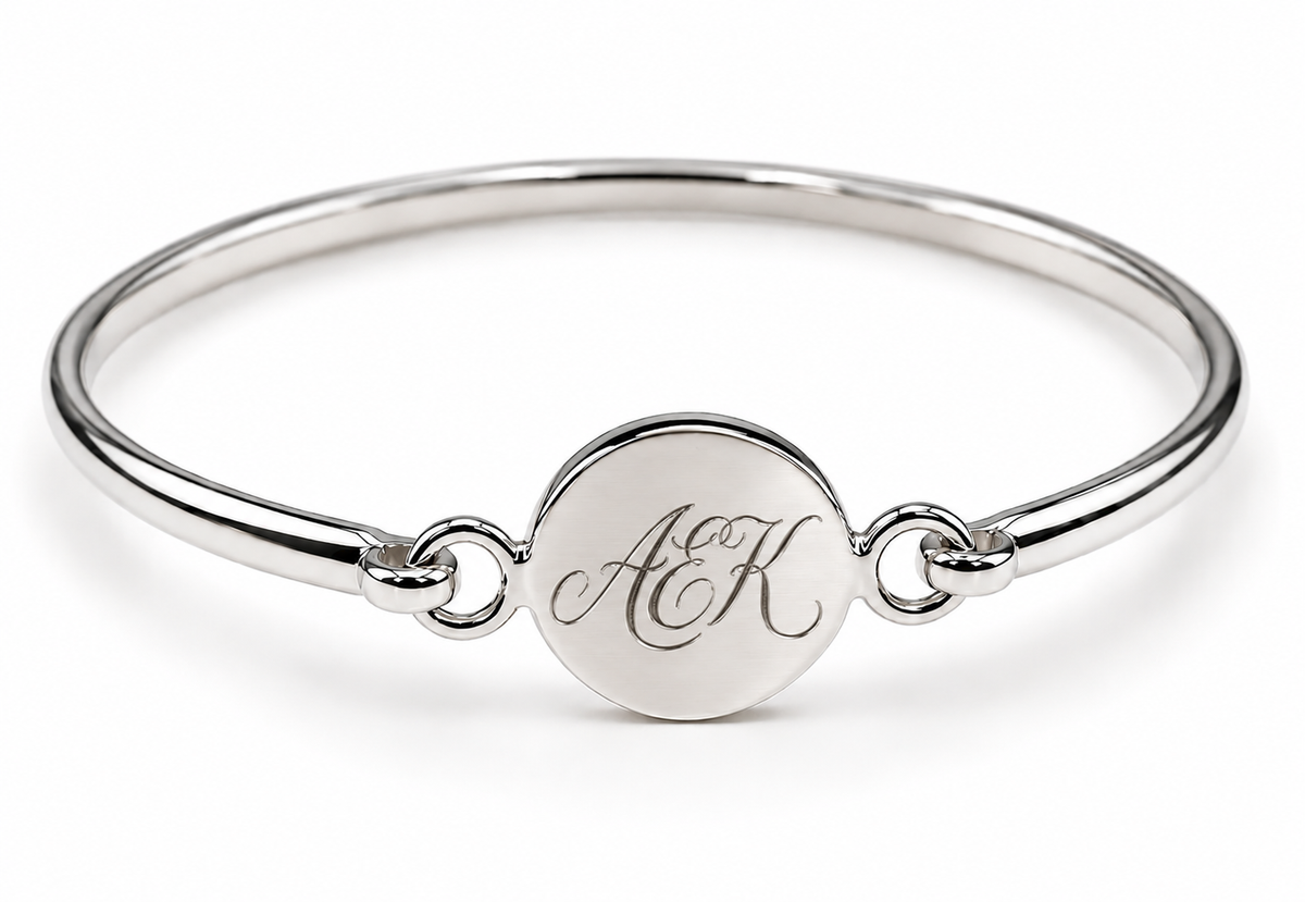 Sterling silver disc bangle showing an ornate AEK monogram engraving example.